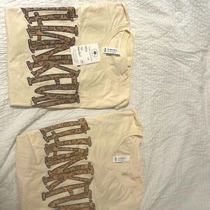 Two cute T-shirts one size small and the other one size large good 4 holidays